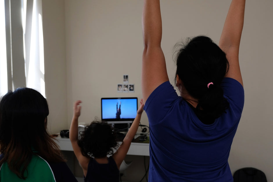 woman in blue t-shirt raising her hands