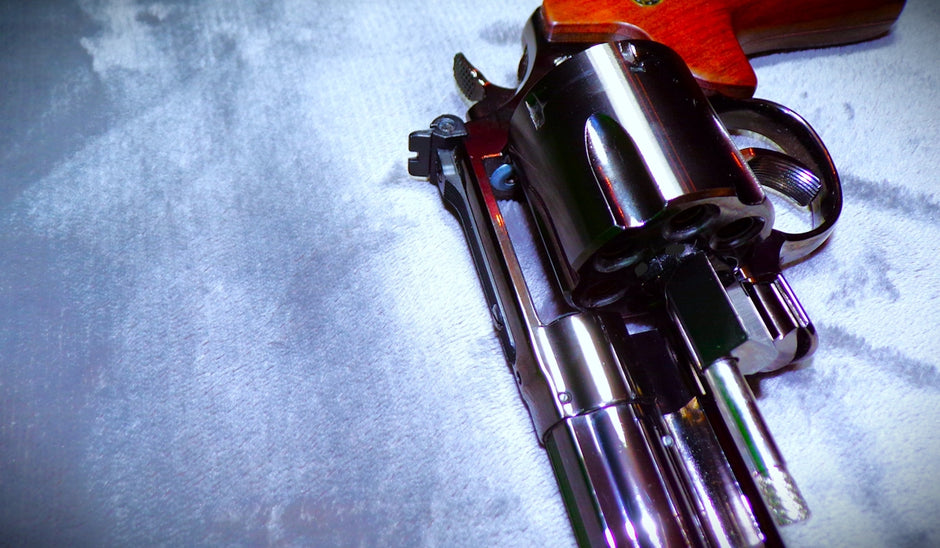 a close up of a gun on a bed