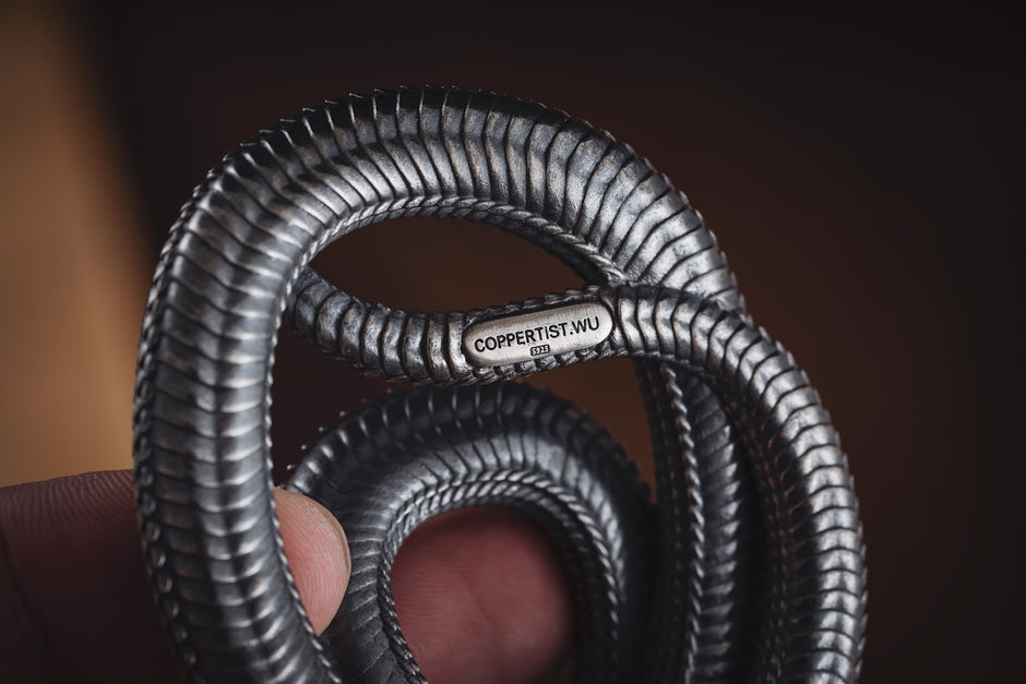 a close up of a person's hand holding a coil