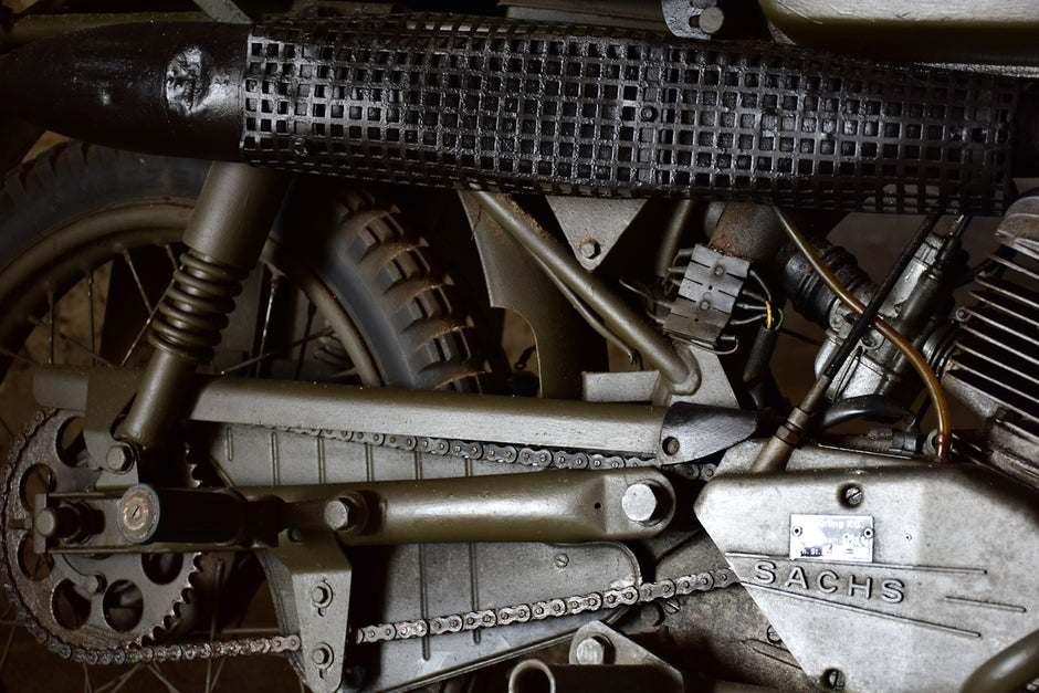 a close up of a motorcycle engine and chain