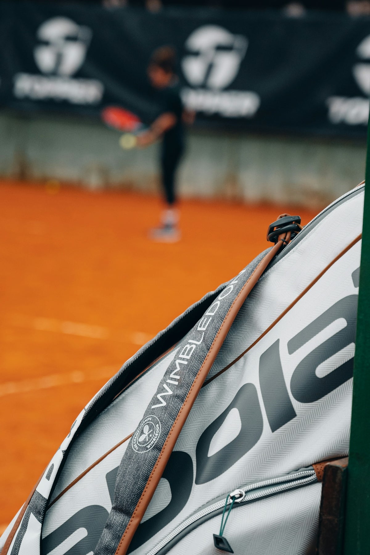 A tennis racket leaning against a racket holder