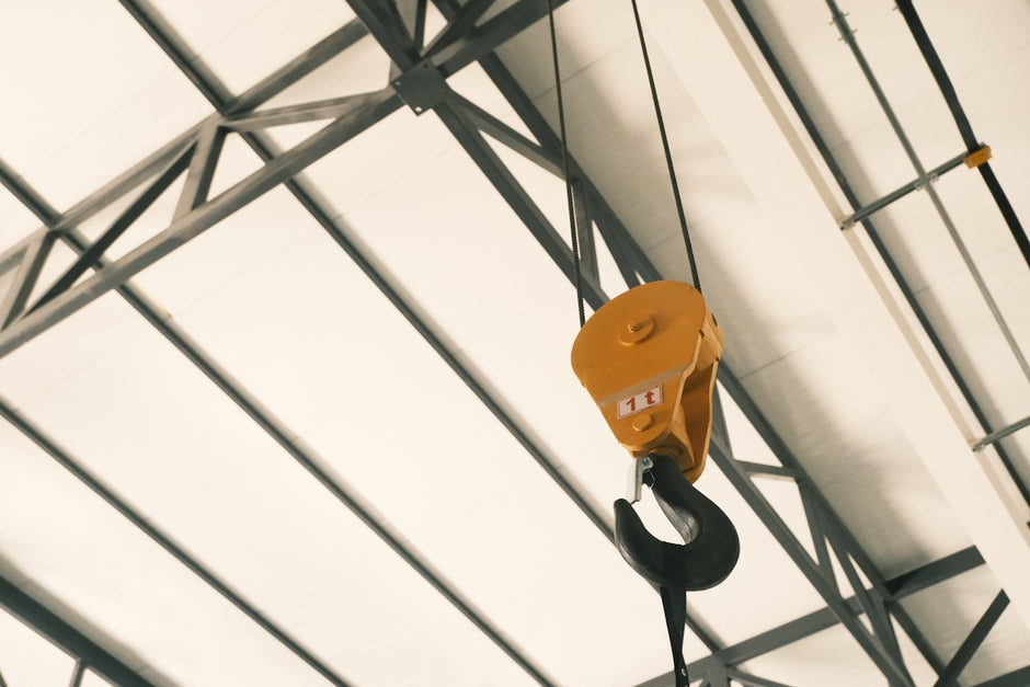 A crane hanging from the ceiling of a building