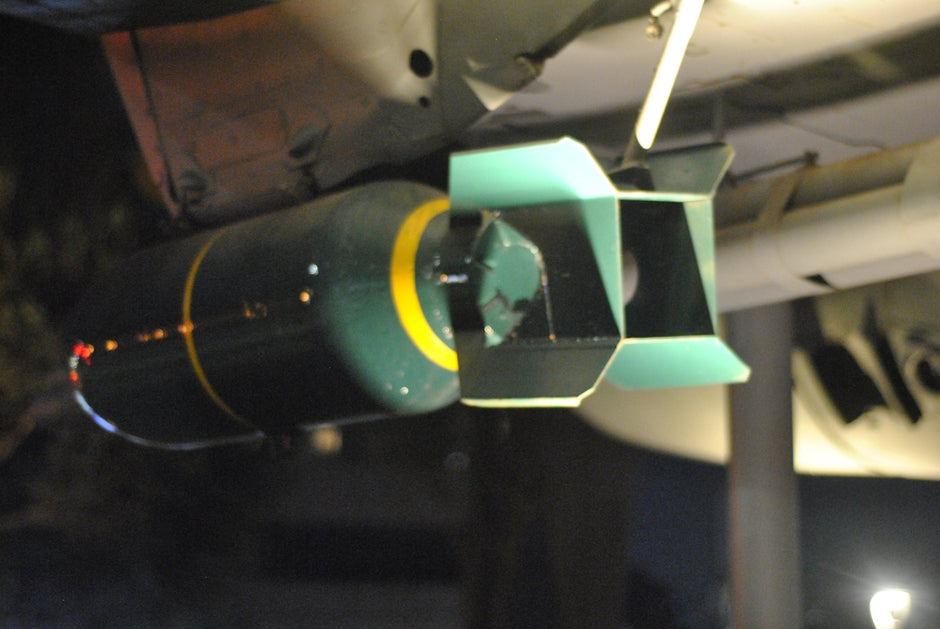 A close-up of a bomb attached to an aircraft.