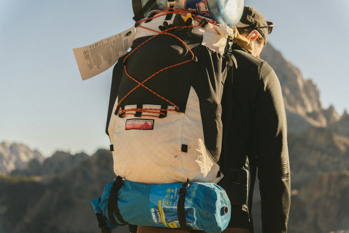 Hiker with large backpack in mountains